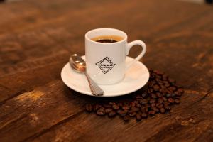 ceramic cup with a regular espresso shot over a wooden table