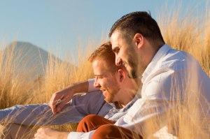 Two men embracing at golden hour
