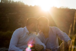 Affectionate same-sex couple in sunset