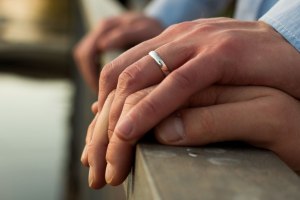 Same-sex couple engagement rings on hands