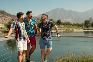 Throuple at a lake with mountains