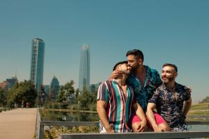 Throuple sitting together in urban setting