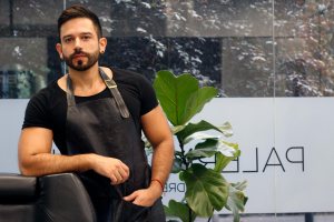 Handsome barber posing in his barbershop
