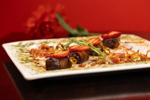 Spanish tapas dish with bacon-wrapped dates.