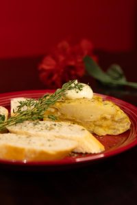 A slice of Spanish potato omelet with bread and aioli.