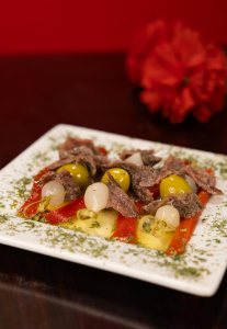 Roasted red peppers with anchovies, olives, and onions.